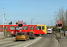 Level crossing near Kingston Park station Tyne&Wear Metrotrain on level crossing.jpg