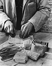 Issuing a family's weekly rations of bacon, margarine, butter, sugar, tea, and lard in 1943 WWII Food Rationing.jpg