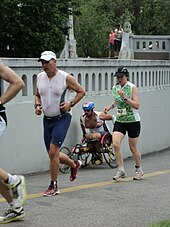 An athlete competes in a wheelchair amongst runners at Ironman 70.3 on the Boise Greenbelt. WheelChairBoiseTriathalon70point3.jpg