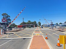 Level crossing with the boom gates partially lowered in a diagonal position