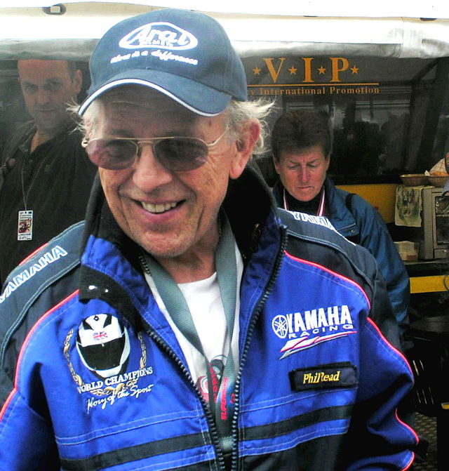 A man in a jacket standing in front of a stall