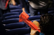 The Atlanta Braves encouraged fans to gesture with the tomahawk chop, distributing foam tomahawks at games and other events. Atlanta Braves fan with tomahawk.jpg