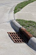 A metal grating covering a storm drain