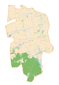 Mapa konturowa gminy Mokrsko, blisko centrum na lewo znajduje się punkt z opisem „Parafiapw. św. Mikołajaw Komornikach”