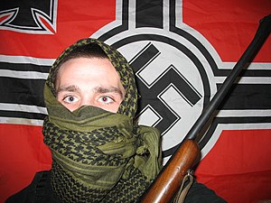 A militant neo nazi in USA holding a 30-.06 rifle.