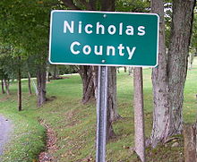A highway sign designating the border between Nicholas and Greenbrier counties in West Virginia along a secondary road NicholasCountySignWV.jpg