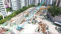 Overview of the construction site with a crane and other construction vehicles