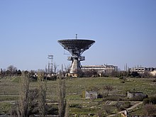 The 32-metre diameter antenna in 2009, along with the partially-completed buildings from the Soviet era TNA-400.jpg
