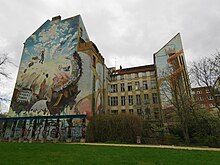 Large apartment block with a mural on one side