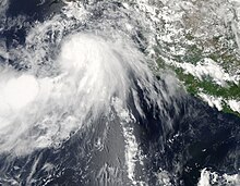 A visible satellite image of a disorganized tropical storm south of Baja California on August 23.