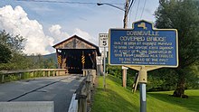 a picture of the historical marker, with the bridge behind it