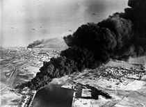 Smoke rises from oil tanks beside the Suez Canal hit during the initial Anglo-French assault on Egypt, 5 November 1956. Port Said from air.jpg