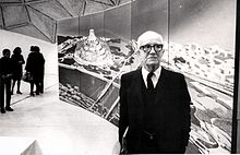 Buckminster Fuller with a drawing of his domed city proposal R. Buckminster Fuller with his domed city design.jpg