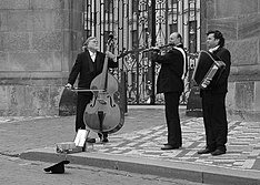 A street performance trio on their pitch outside Prague Castle