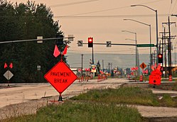 Van Horn Road westbound at South Cushman Street in June 2012. In the background is a portion of the business district which runs along the CDP's northern edge.