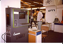 Early Automatix (now part of Omron) machine vision system Autovision II from 1983 being demonstrated at a trade show. Camera on tripod is pointing down at a light table to produce backlit image shown on screen, which is then subjected to blob extraction. AutovisionIIatRDT.jpg