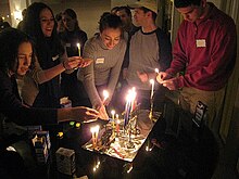 Members of the DC Minyan light candles in celebration of the Festival of Hanukkah. DCMinyan Hanukkah.JPG