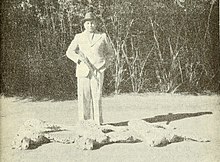 Maharaja Ramanuj Pratap Singh Deo standing beside the bodies of the last three wild cheetahs in India