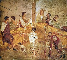 A multigenerational banquet depicted on a wall painting from Pompeii (1st century AD) Pompeii family feast painting Naples.jpg