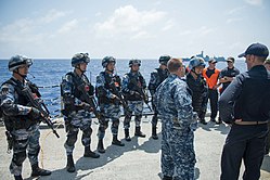 Sailors from the U.S. Navy talk with Chinese Navy sailors from the destroyer Xi'an after the Rim of the Pacific 2016 (RIMPAC 2016) exercise RIMPAC 160720-N-KM939-138.jpg