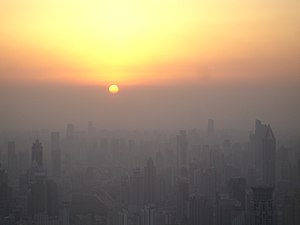 Puxi area of Shanghai at sunset. The sun has not actually dropped below the horizon yet, rather it has reached the smog line.