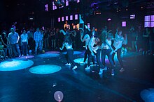 Color photograph of people dancing in a nightclub (Brasil Tropical).