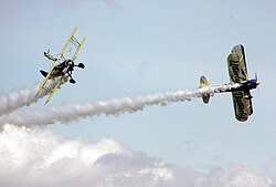 The UK Utterly Butterly display team perform an aerobatic maneuvre with their Boeing Stearmans