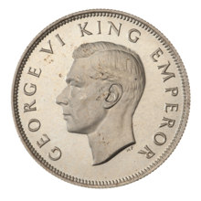 A crowned portrait of George V in royal dress, with the encircling text GEORGE V KING to the left, and EMPEROR to the right.