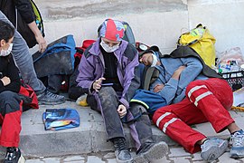 Emergency workers resting on a street.