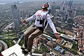 Image 6 BASE jumping Photograph credit: Kontizas Dimitrios BASE jumping is the recreational sport of jumping from fixed objects, using a parachute to descend safely to the ground. The acronym stands for four categories of fixed objects from which the jumps can be made: buildings, antennae, spans, and earth (cliffs). In this photograph, a BASE jumper launches himself from the top of the Sapphire Tower in Istanbul, Turkey. More selected pictures