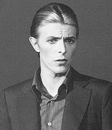 A black and white image of Bowie looking towards the camera