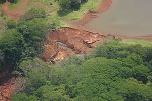 A close-up aerial photo of the Ka Loko Dam bre...