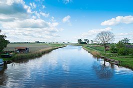 Gezicht op het hergraven deel van de Lauwers ten zuiden van de nieuwe sluis met rechtsachter het dierenpark van De Schans en rechtsvoor de plek waar boten te water kunnen worden gelaten.