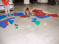 A supervised child learning the countries of Asia on the floor of the central hall of the Field Museum, Chicago, Illinois 