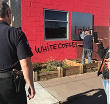 Clean up effort by the City of Denver at ink! Coffee in Five Points, Denver. The coffee shop was vandalized following the debut of a controversial ad campaign. Vandalism Following Controversial Gentrification Ad .jpg