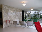 Villa interior, with chairs and an onyc wall