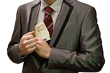A black-market salesman (fly by night) depicted making a transaction 3 - corruption - man in suit - white background - euro banknotes hidden in right jacket inside pocket - royalty free, without copyright, public domain photo image.JPG