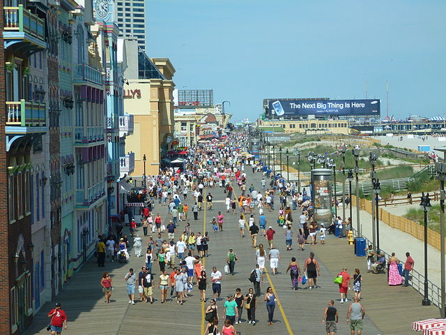  Many people walking on a boardwalk at the beach in Atlantic City, New Jersey