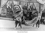 1921 Chinese lion dance in front of the East Kong Yick Building