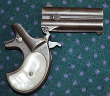 Remington Model 95 with pearl grips and barrels open for reloading Derringer open.png