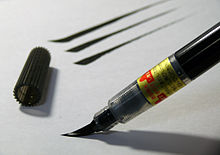 Imagen de una pluma con pincel que se utiliza para aplicar tinta al papel..