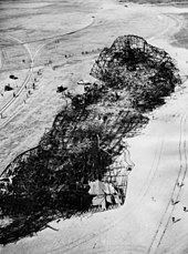 The wreckage of the Hindenburg the morning after the crash. Some fabric remains on the tail fins. Hindenburg wreckage 1937.jpg