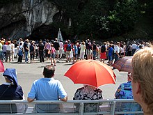 Pilgrims at Lourdes, a place Dawkins visits in the documentary. Lourdes Grotte.jpg