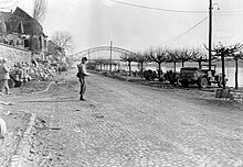 A 9th Infantry Division MP stands guard along the Rhine at Erpel, Germany on 13 March 1945 MP in Erpel at Ludendorff Bridge.jpg