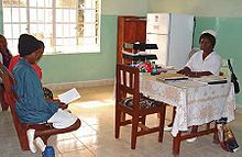 Nurse at Koidu Hospital in Sierra Leone consulting with patients. Nurse at Koidu Hospital Sierra Leone.jpg