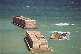 A pair of surviving Phoenixes, and the remains of a third, at Arromanches, 2010 The Phoenix breakwaters (1).jpg