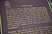 Text reads "For over a century African Canadians settled here, developing an independent community centred around church and family. As part of the urban renewal projects of the 1960s, officials introduced a plan to level the community and relocate its residents. The community mobilized and even though no buildings were saved, Africville became a symbol of the ongoing struggle by African Canadians to defend their culture and their rights. Seaview Park, created on the site as a memorial to Africville, speaks to the enduring significance of community."