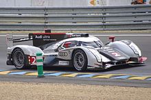 Side view of a silver and black Audi R18 TDI in action