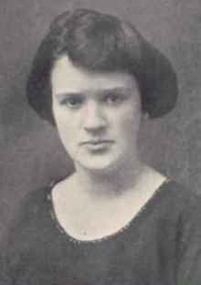 A yearbook photo of a young white woman with bobbed dark hair