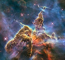 A pillar of gas and dust in the Carina Nebula. This Wide Field Camera 3 image, dubbed Mystic Mountain, was released in 2010 to commemorate Hubble's 20th anniversary in space. HH 901 and HH 902 in the Carina nebula (captured by the Hubble Space Telescope).jpg